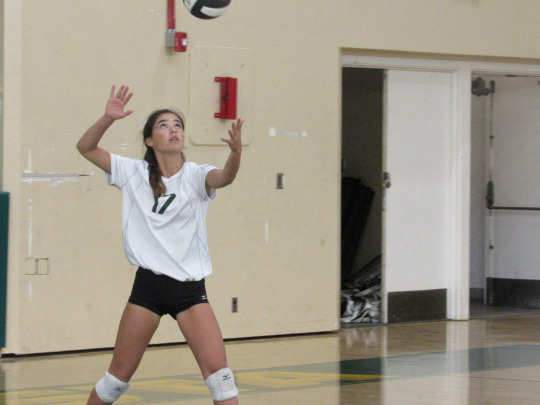 Sophomore Malia Yuhl begins her serve, starting the game against the Inglewood Girls.