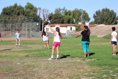 Mira Costa’s Rugby coach tells the team what to do in the drill they are about to do.