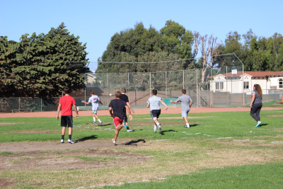 Rugby players scrimmage with themselves at the end of their practice. 