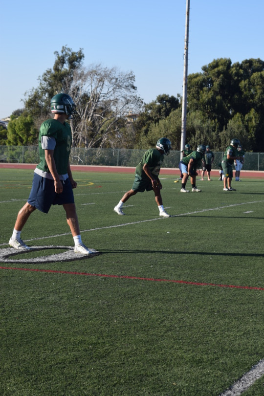 Senior wide receivers Alec Oshita and Sean Walker line up next to junior running back Jonah Tavai and sophomore quarterback Reed Vabrey before an offensive play. 