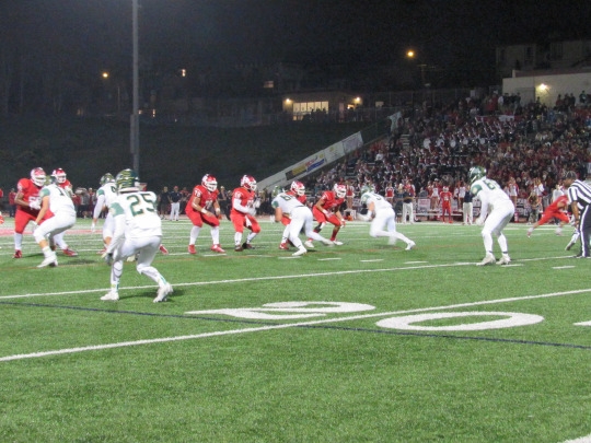 Mira Costa Sophomore Romeo Galasso charges through the Redondo Defensive Line in attempt to advance the ball to the end zone.