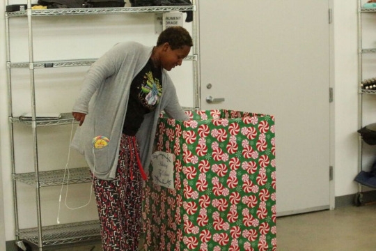 Senior Amanda McDonald puts a toy in the toy collection box that is located in the band room this Monday during 6th period. The S club put toy collection boxes around campus for students to donate toys to the Toy Drive. 