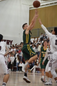 Senior point guard Ryan White puts up a fadeaway jump shot against a Torrance defender in the boys varsity basketball game on December 13th.
