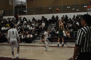 Senior Jackson Weaver shoots the ball from the 3 point line.