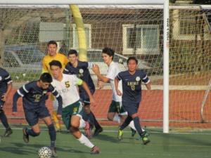 Mira Costa Senior James Marsh pushes against the Animo opponent in order to keep the ball on the offensive side.