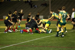 Players rush to help their teammate keep possession of the ball.