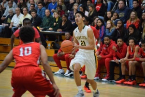 Senior Brandon Chan lifts his head to look for an open teammate to pass the ball to.