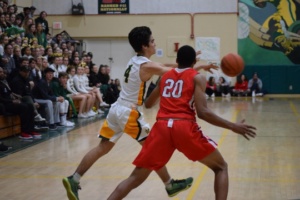 Junior Morgan Clark is in mid-pass position, passing the ball to one of his Costa teammates.