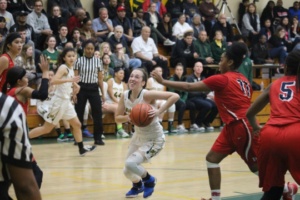 Mira Costa Junior Haley Herdman charges through her opponent at the Mira Costa Girls Varsity Basketball game on Tuesday night.