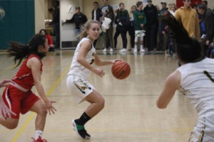 Mira Costa Junior Jennifer Brooks maneuvers around her Redondo Beach opponent in an attempt to make a successful pass to her teammate nearest the basket.