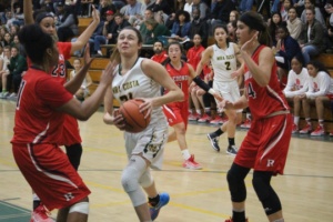 Mira Costa Senior Allie Navarette strides towards the basket in a successful attempt to score for the Mira Costa Girls.