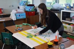 Senior Leah James constructs a sign for the varsity boys soccer Senior Night during fifth period in the ASB room on Thursday. The varsity squad beat Palos Verdes on Tuesday, January 31st, and will take on Inglewood at home for their Senior Night on February 3rd.