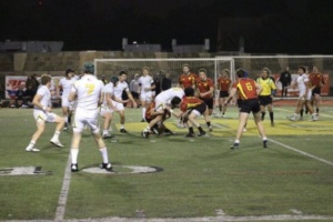 One Costa Rugby player attempts to run through the opposing team to score for the Mustangs, but gets tackled by them. Costa had many attempts to score tries during the game, but lost by one try. 