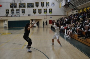 Junior Kelli Toyooka holds the ball away from the opposing team while looking for an open teammate to pass the ball to. Toyooka was the point guard during this game so she brought the ball down the court and looked for open players. 