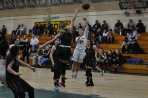 Junior Kelli Toyooka shoots the ball during the second half against Edison. Toyooka was able to shoot even though the other team was guarding her, allowing her other teammates to get the rebound. 