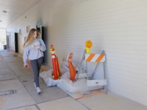 Sophomore Katherine Yollin walks through the ongoing painting of the outside of the health classroom at the beginning of lunchtime. The project began late February and has made much progress.