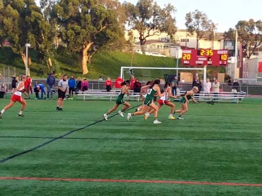 Costa varsity switches into defense after losing the ball on the opposite end of the field. The three Costa girls attempt to box in the Redondo player in order to corner her.